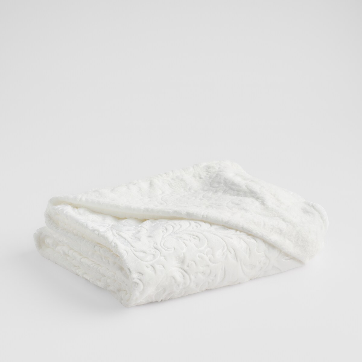 Jednokolorowy koc z wytłoczonym wzorem Conosinos 150x200 cm z motywem arabeski