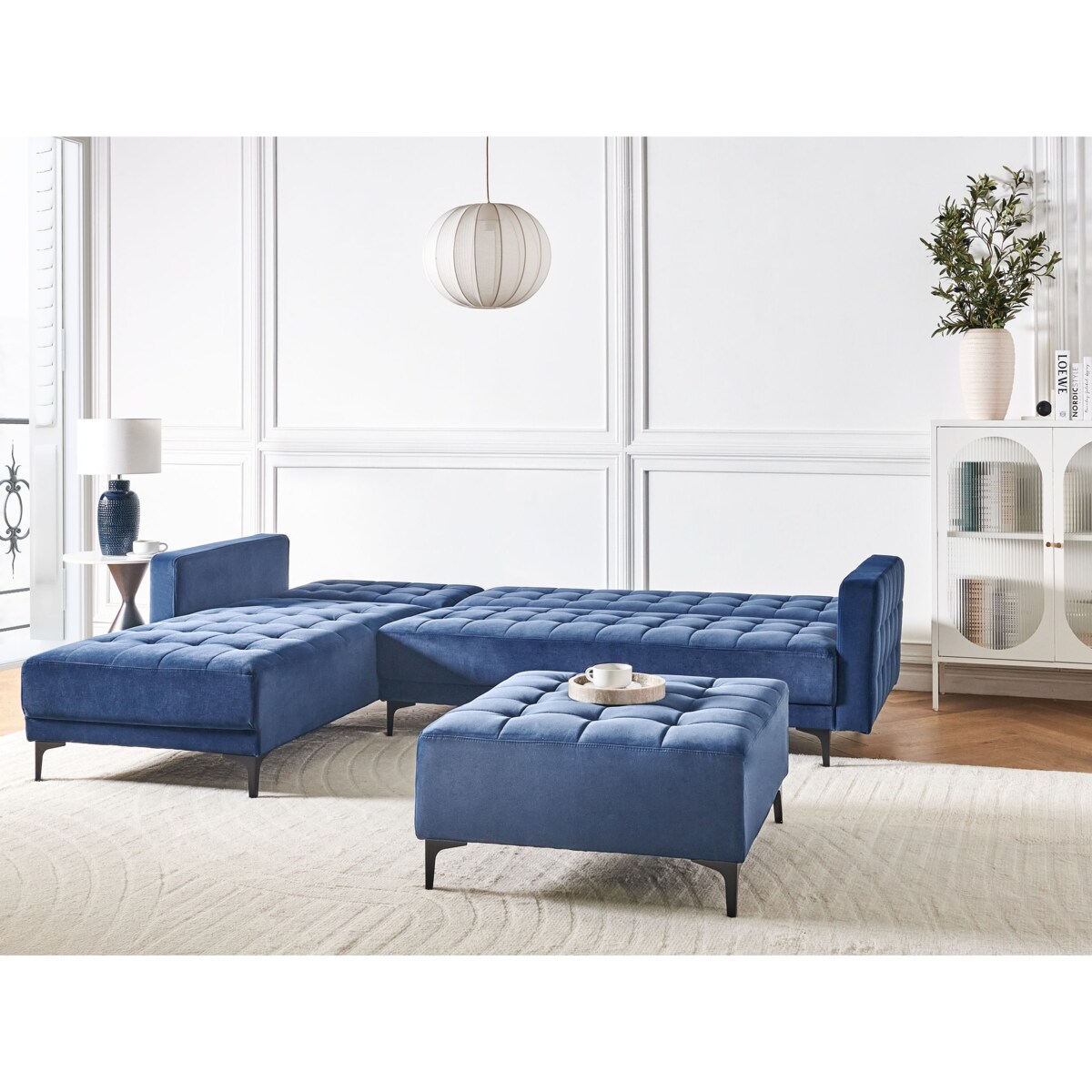 Sofa rozkładana prawostronna welurowa z otomaną niebieska ABERDEEN