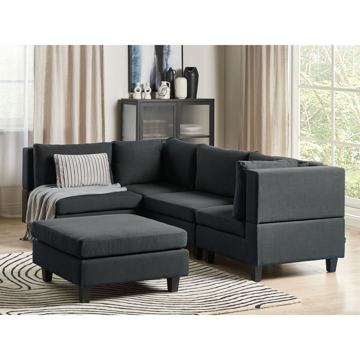 Tapicerowany prawostronny narożnik modułowy 4-osobowy z otomaną czarny UNSTAD